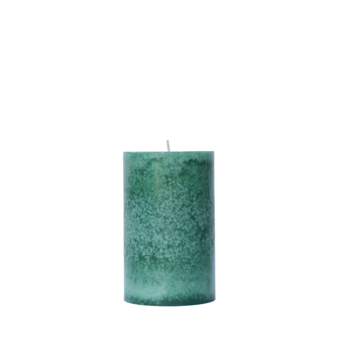 A single handcrafted pillar candle featuring a mottled wax finish with a distinct snowflake-like pattern in a solid winter green hue.