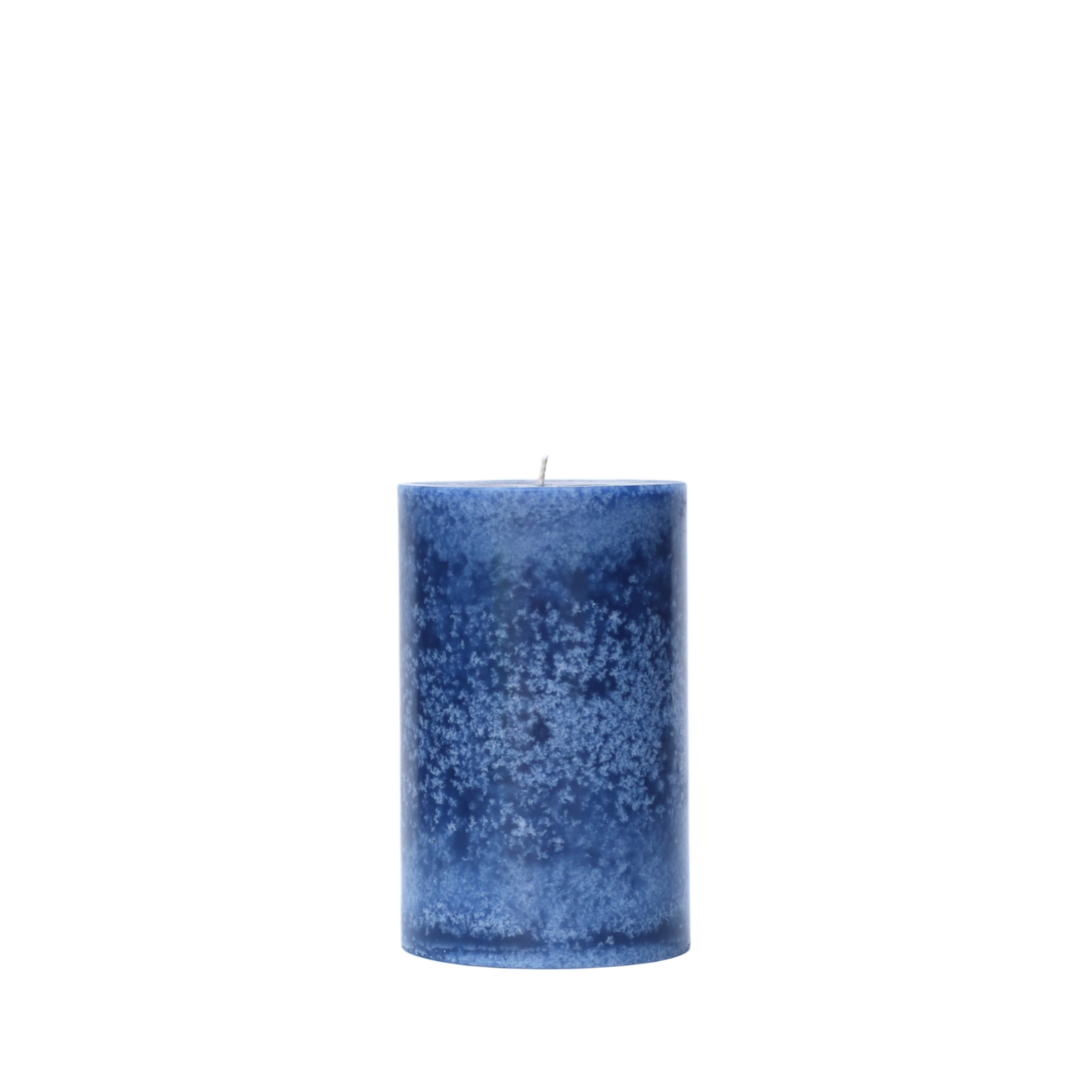 A single handcrafted pillar candle featuring a mottled wax finish with a distinct snowflake-like pattern in a solid navy blue hue.