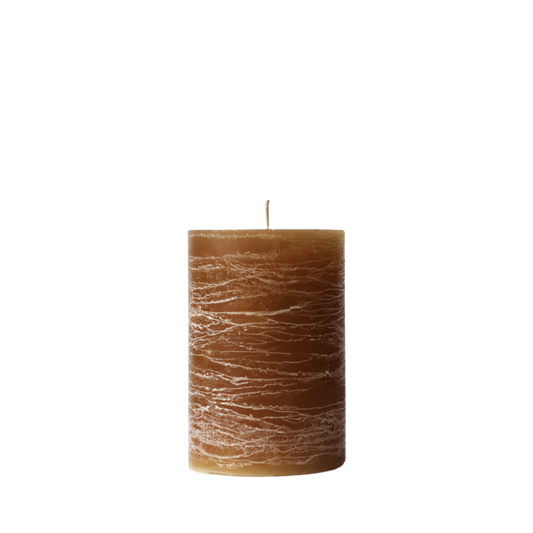 A minimalist Nordic-style pillar candle in a solid brown, featuring horizontal textured lines and a handcrafted rustic finish.