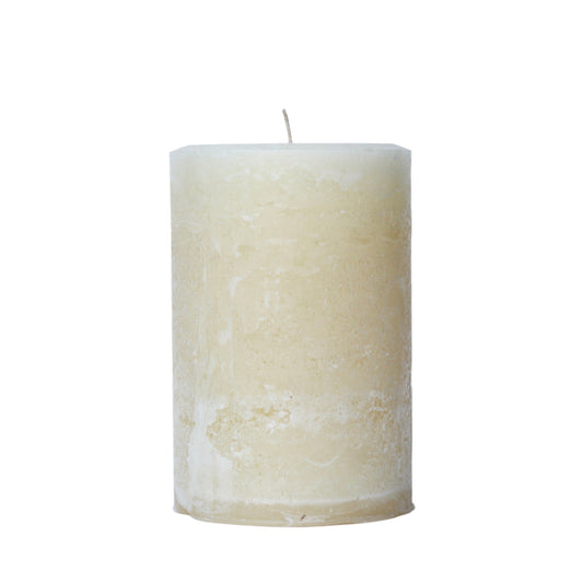 A handcrafted bright lake blue pillar candle with a 'Petrified' rustic texture, showing a weathered, frosted, stone-like finish in classic ivory tones. 