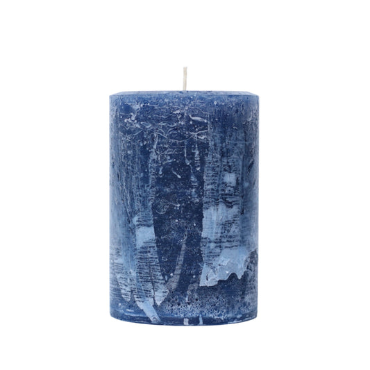 A handcrafted navy blue pillar candle with a 'Petrified' rustic texture, showing a weathered, frosted, stone-like finish in navy blue tones. 