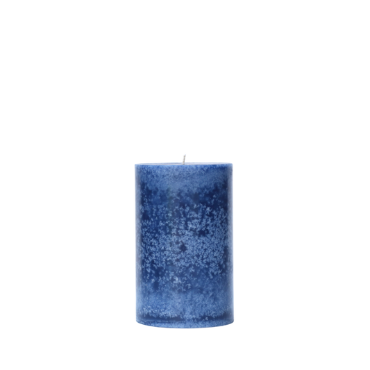 A single handcrafted pillar candle featuring a mottled wax finish with a distinct snowflake-like pattern in a solid navy blue hue.