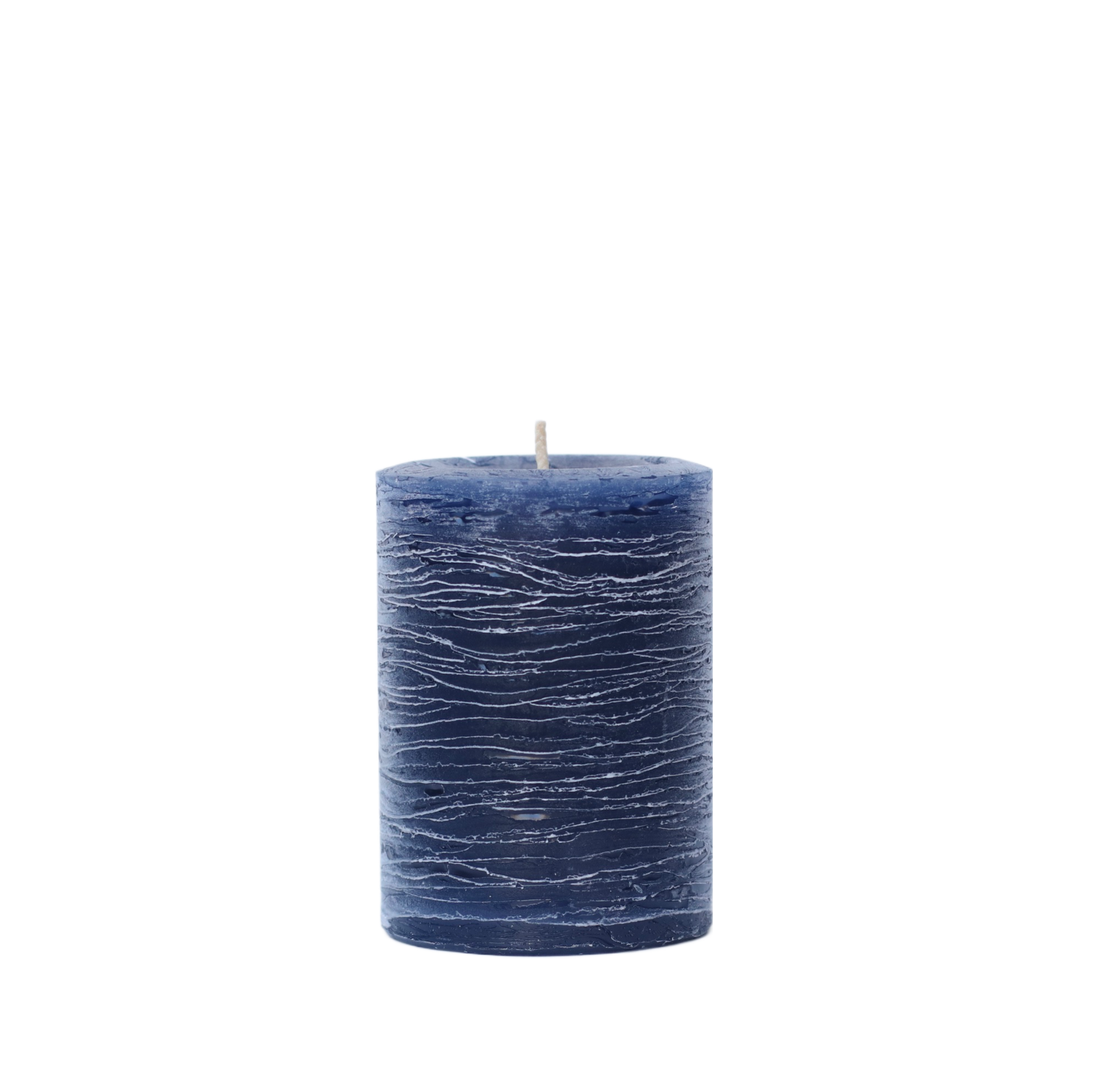 A minimalist Nordic-style pillar candle in a solid navy blue, featuring horizontal textured lines and a handcrafted rustic finish.