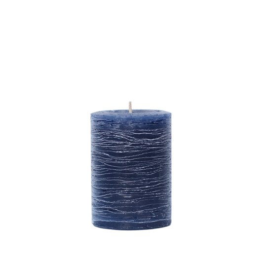 A minimalist Nordic-style pillar candle in a solid navy blue, featuring horizontal textured lines and a handcrafted rustic finish.