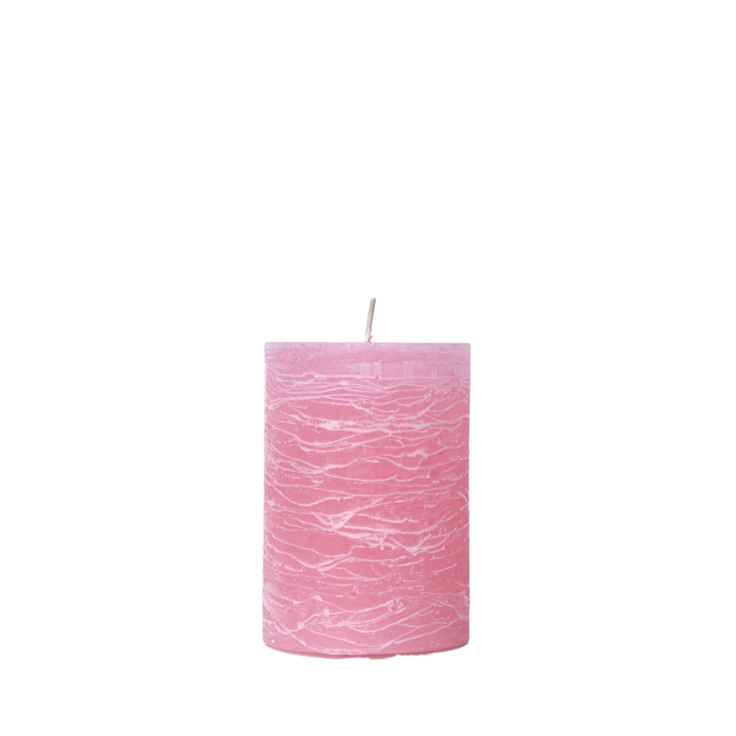 A minimalist Nordic-style pillar candle in a solid pink, featuring horizontal textured lines and a handcrafted rustic finish.
