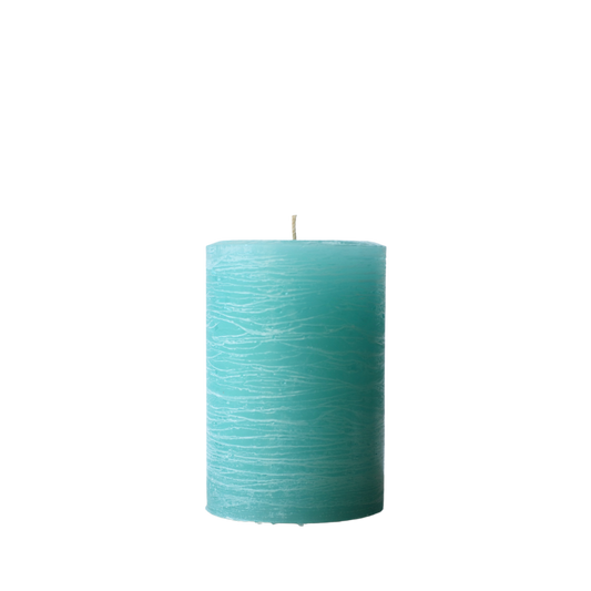 A minimalist Nordic-style pillar candle in a solid turquoise, featuring horizontal textured lines and a handcrafted rustic finish.