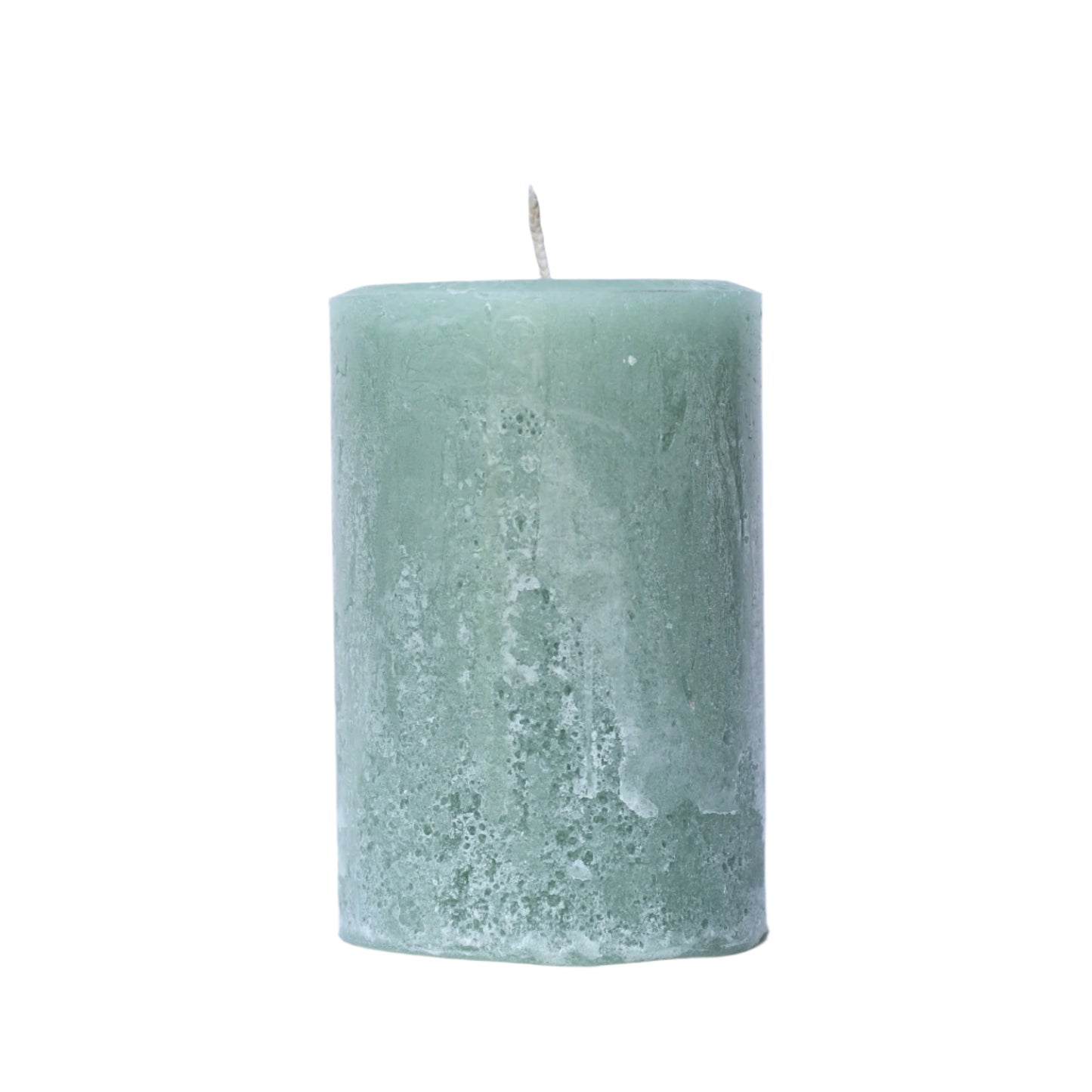 A handcrafted sage green pillar candle with a 'Petrified' rustic texture, showing a weathered, frosted, stone-like finish in muted herb tones. 