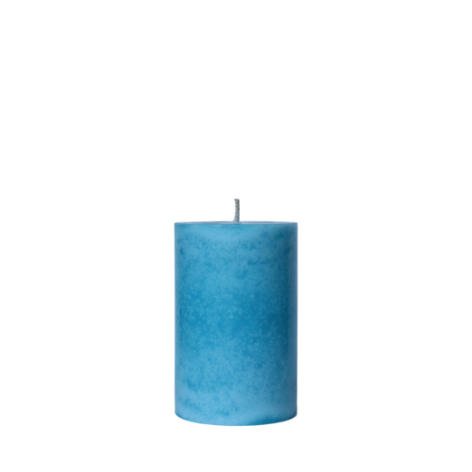 A single handcrafted pillar candle featuring a mottled wax finish with a distinct snowflake-like pattern in a solid bright teal hue.