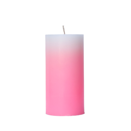 A 6-inch tall pillar candle featuring a smooth color gradient that fades from a crisp white top to a medium shade of shocking pink base.
