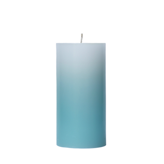 A 6-inch tall pillar candle featuring a smooth color gradient that fades from a crisp white top to a bluish green turquoise base.